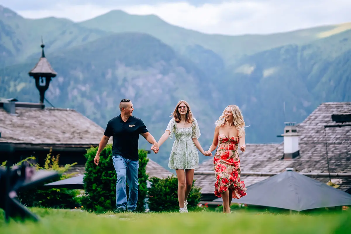Elena, Joe, and Alexis walking hand in hand in the Austrian mountains