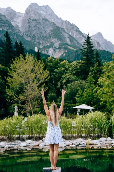 Elena celebrating beside a mountain pool