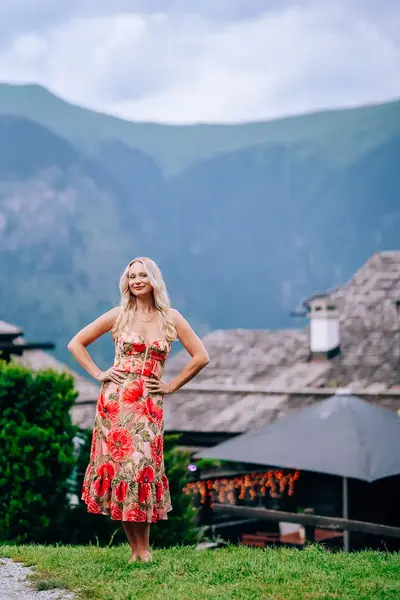 Elena in a floral dress in the mountains