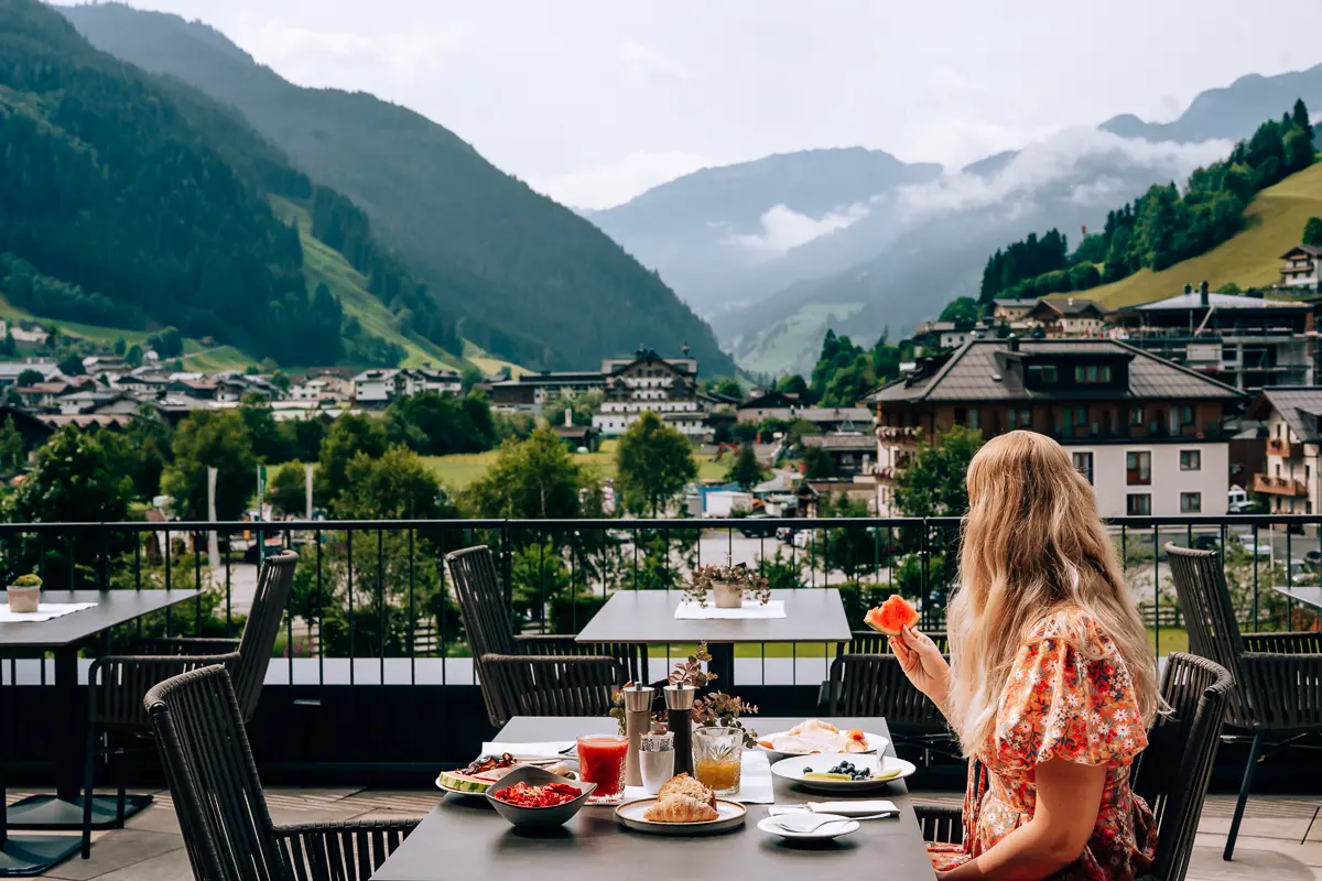 Elena having breakfast overlooking a mountain village