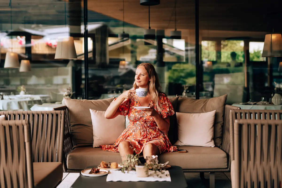Elena enjoying tea on a terrace